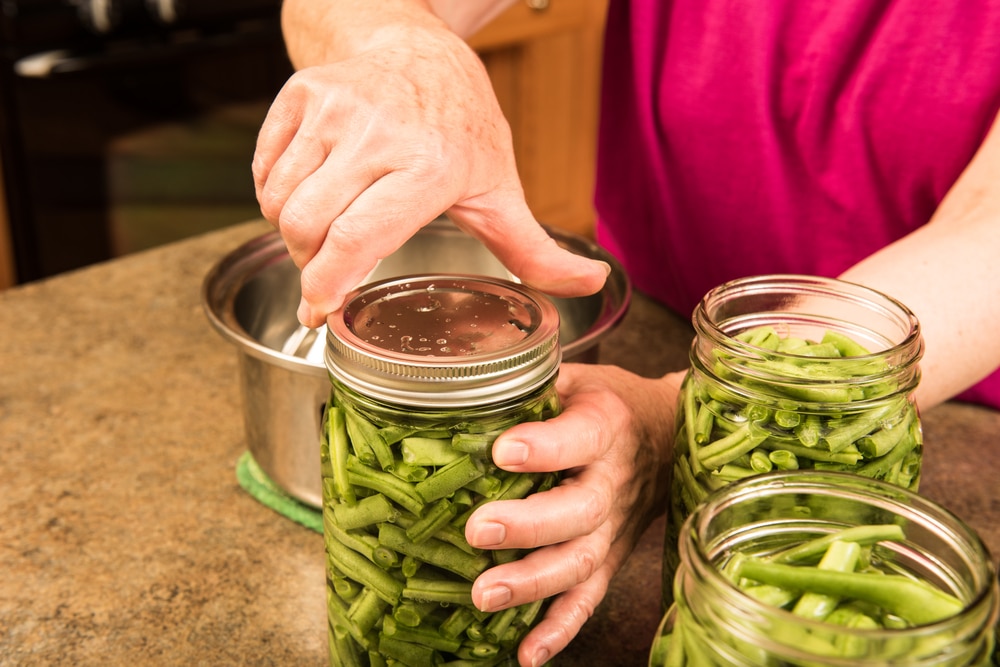 A view of a person canning beans