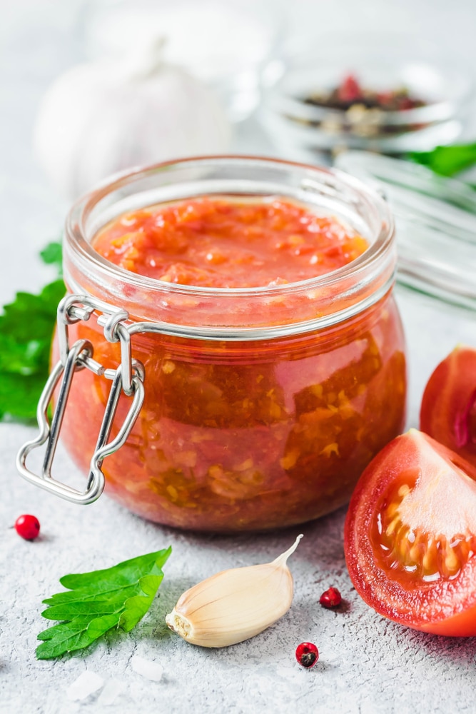 A view of marinara sauce inside a glass jar