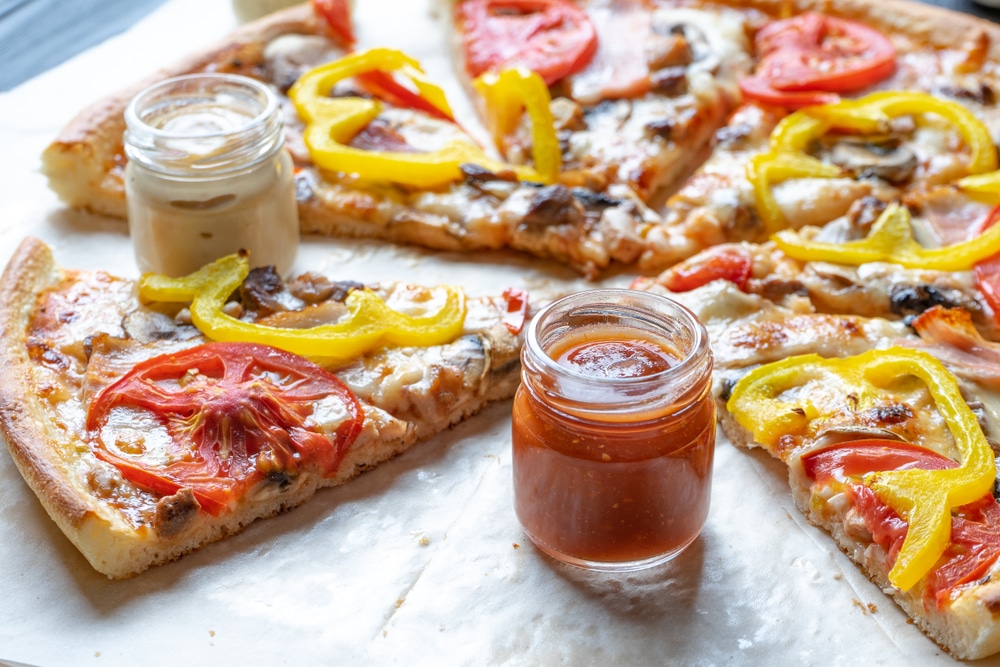 Close Up View On Sliced Pizza With Sauce For Pizza