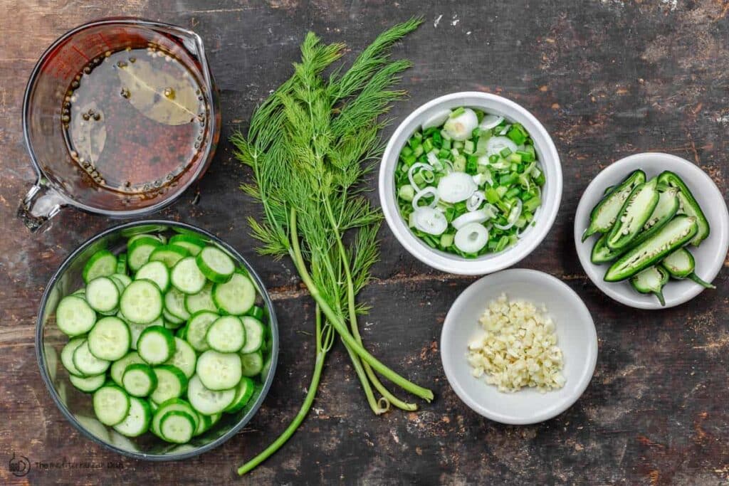 A top view of ingredients to use in bowls for cucumber pickle recipe