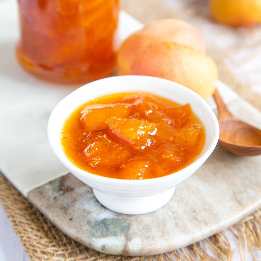 A view of apricot jam in a white bowl