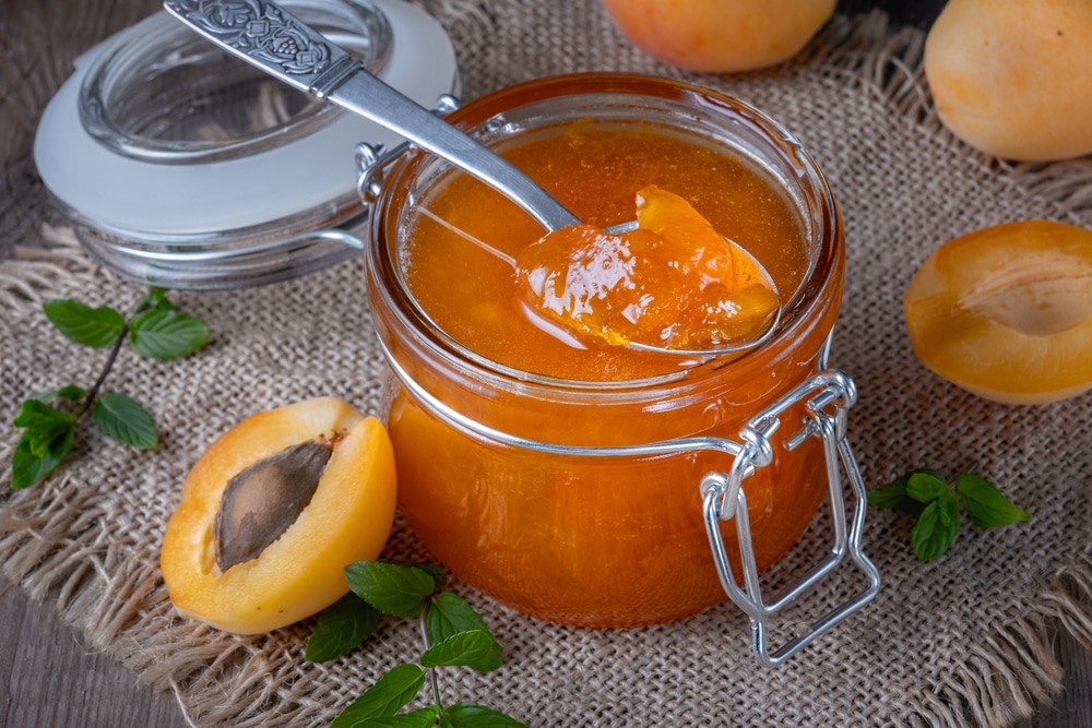 A view of apricot jam inside a glass jar