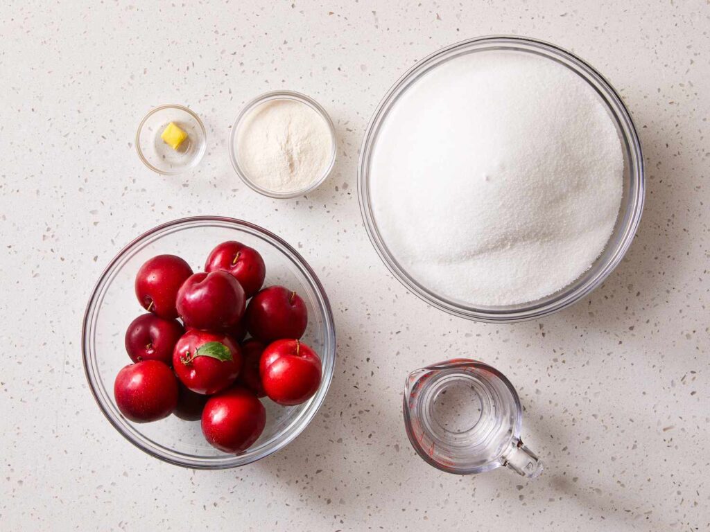 A view of ingredients for plum jam sugar and plums and water