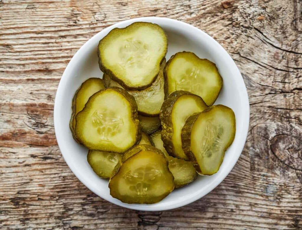 A view of pickled cucumbers in a bowl