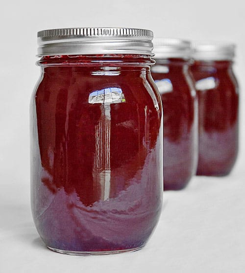 A view of plum jam inisde a canned jar