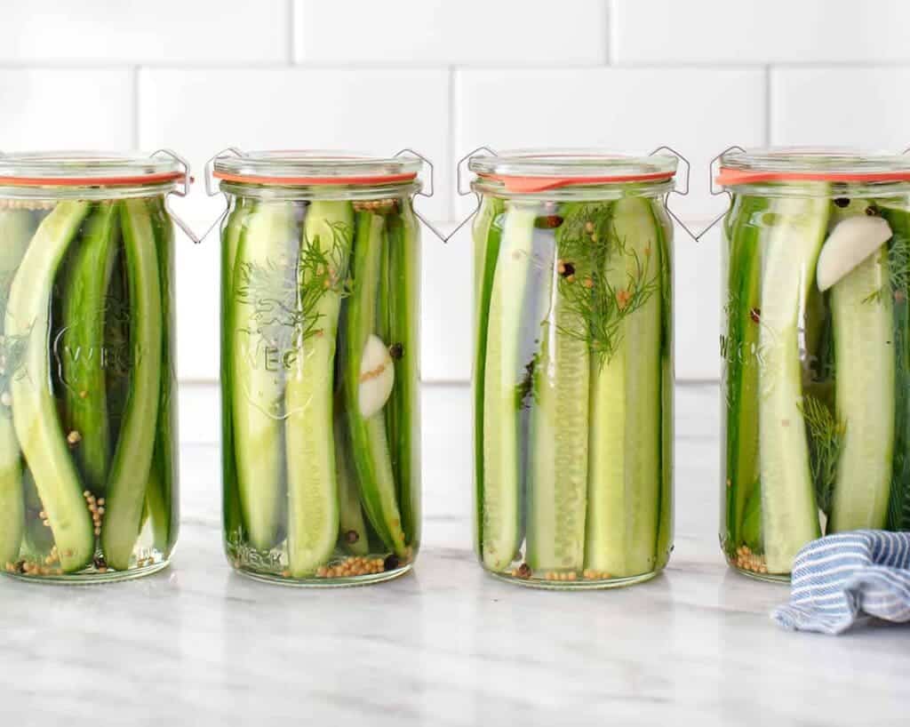 glass jars of fresh dill pickle with the lids on