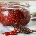 fig preserve in a jar along with the spoon full of fig jam