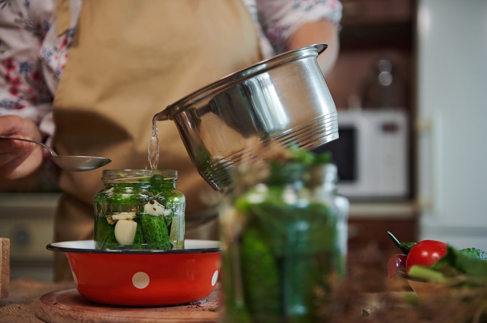 Cropped View Housewife Pouring Boiling Marinade From Saucepan Into A