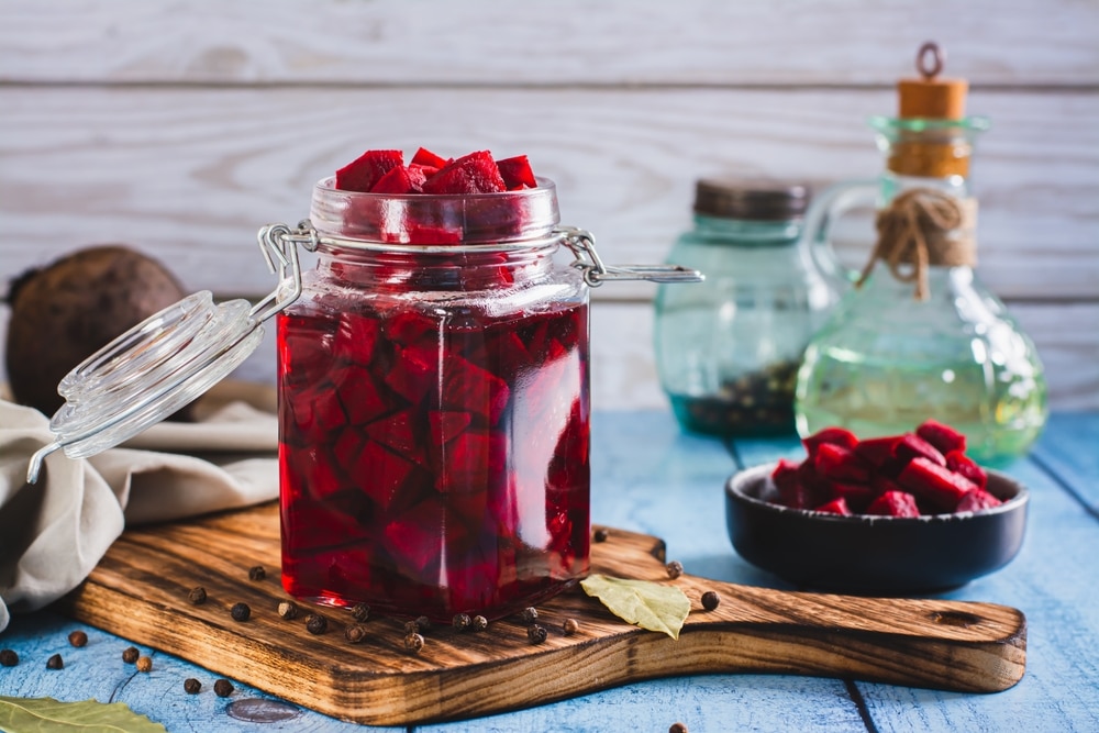 Pieces Of Fermented Beets In A Jar And Spices On