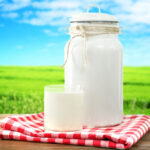 Retro Can For Milk And Glass Of Milk On Wooden