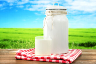 Retro Can For Milk And Glass Of Milk On Wooden