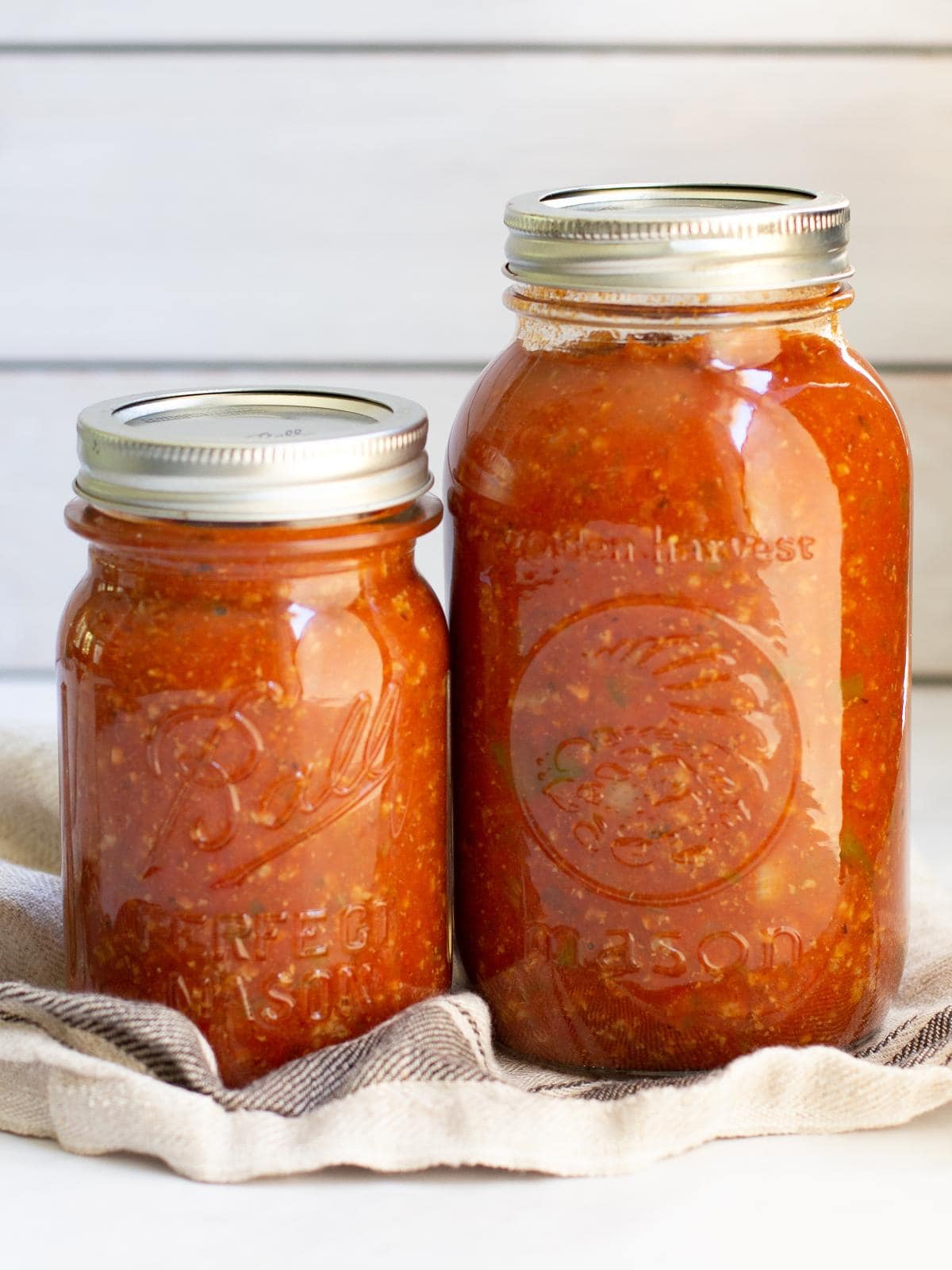 large and small jars of canned chili