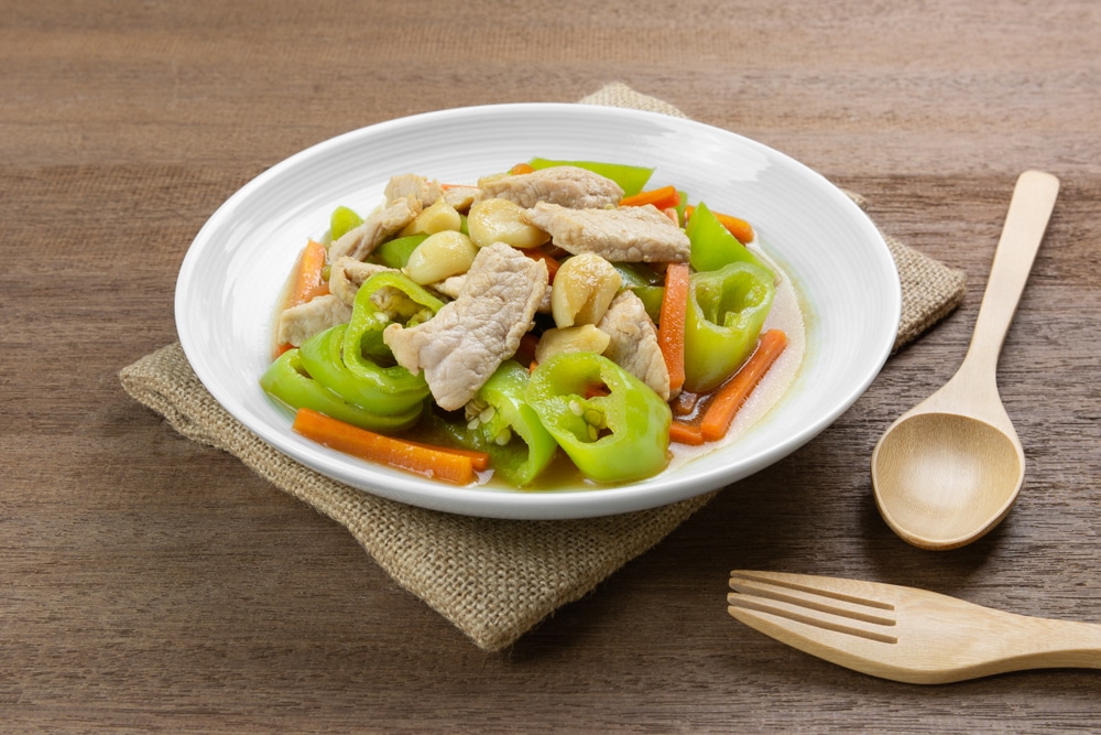 Stir Fried Pork With Banana Pepper In A Ceramic Dish