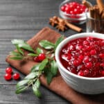 Fresh Cranberry Sauce Served In Bowl On Grey Wooden Table