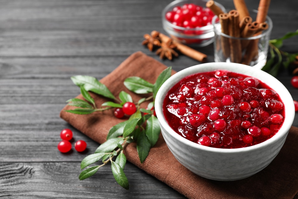 Fresh Cranberry Sauce Served In Bowl On Grey Wooden Table