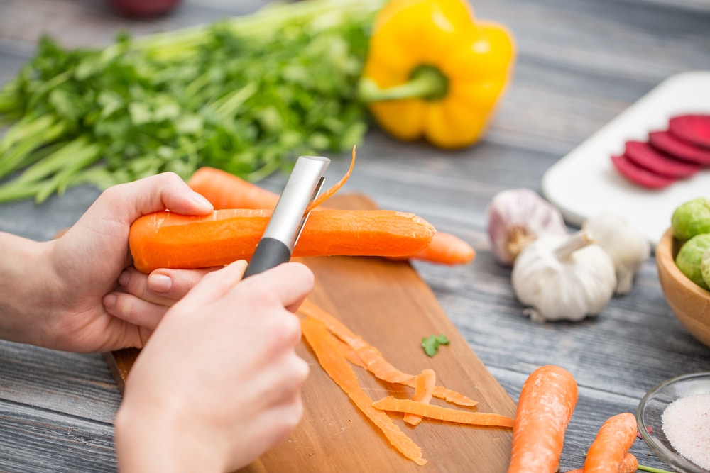 Preparing A Meal Peeling Vegetables