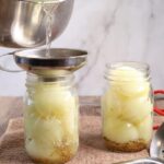 A view of canning process being performed throgh a funnel