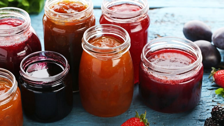 A view of jams and jellies inside jars A view of jams and jellies inside jars