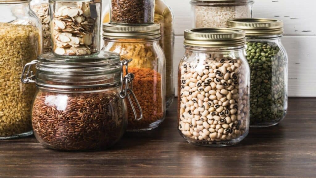 A vacuum sealing tool attached to a mason jar removing air to create a vacuum seal A vacuum sealing tool attached to a mason jar removing air to create a vacuum seal