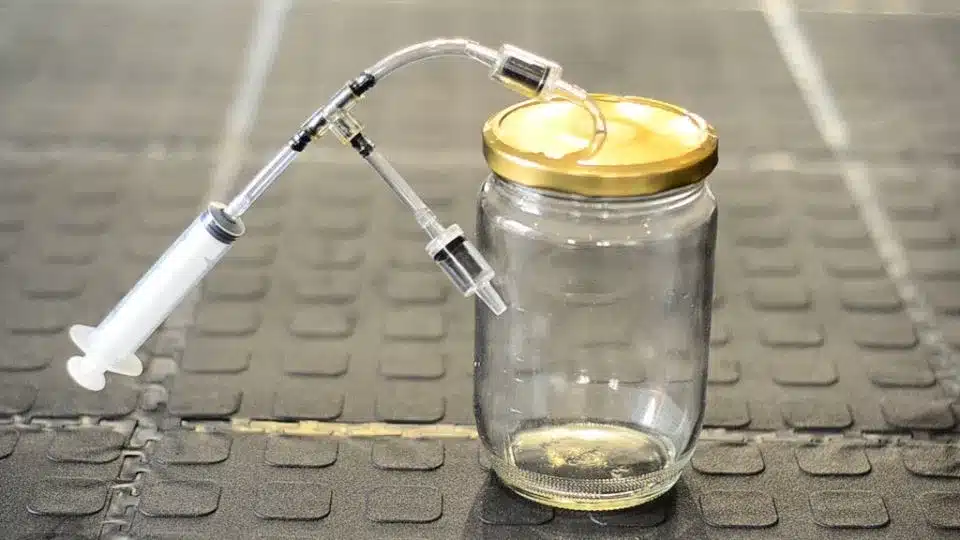 Jars being processed in a boiling water bath canner Jars being processed in a boiling water bath canner